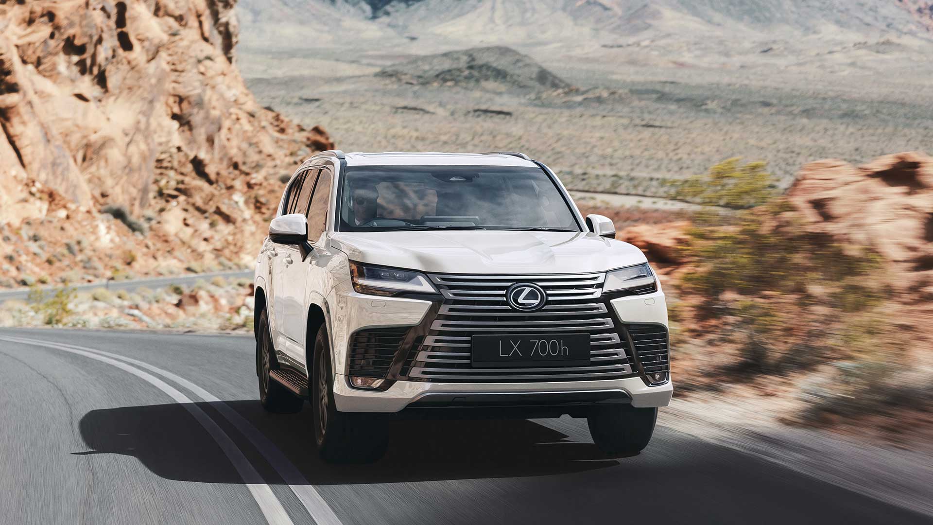 Lexus LX 700h Hybrid SUV driving through outback country