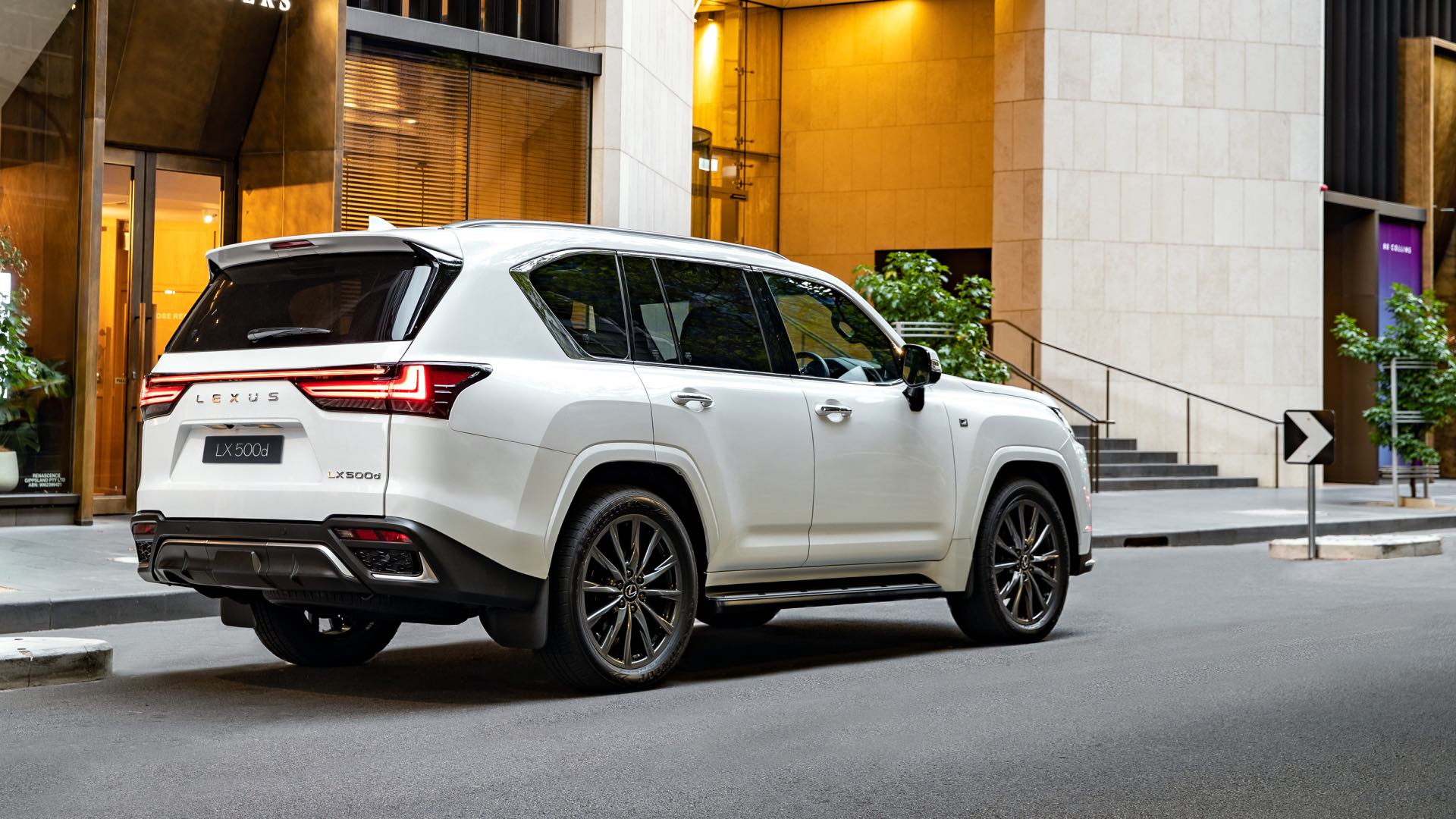 Lexus LX F Sport parked on the side of a city street.